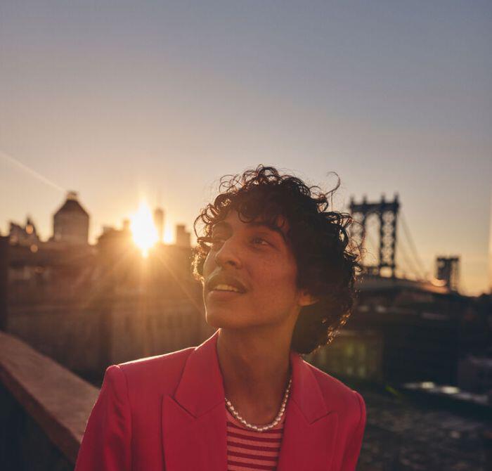 Man in front of Brooklyn Bridge at sunset